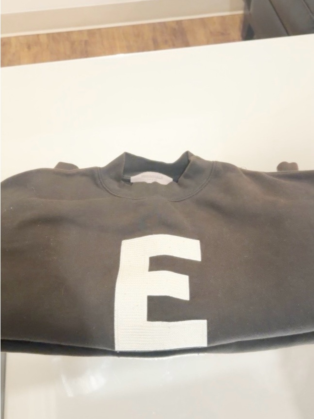 Essentials Black Crewneck Sweater with White 'E' Graphic